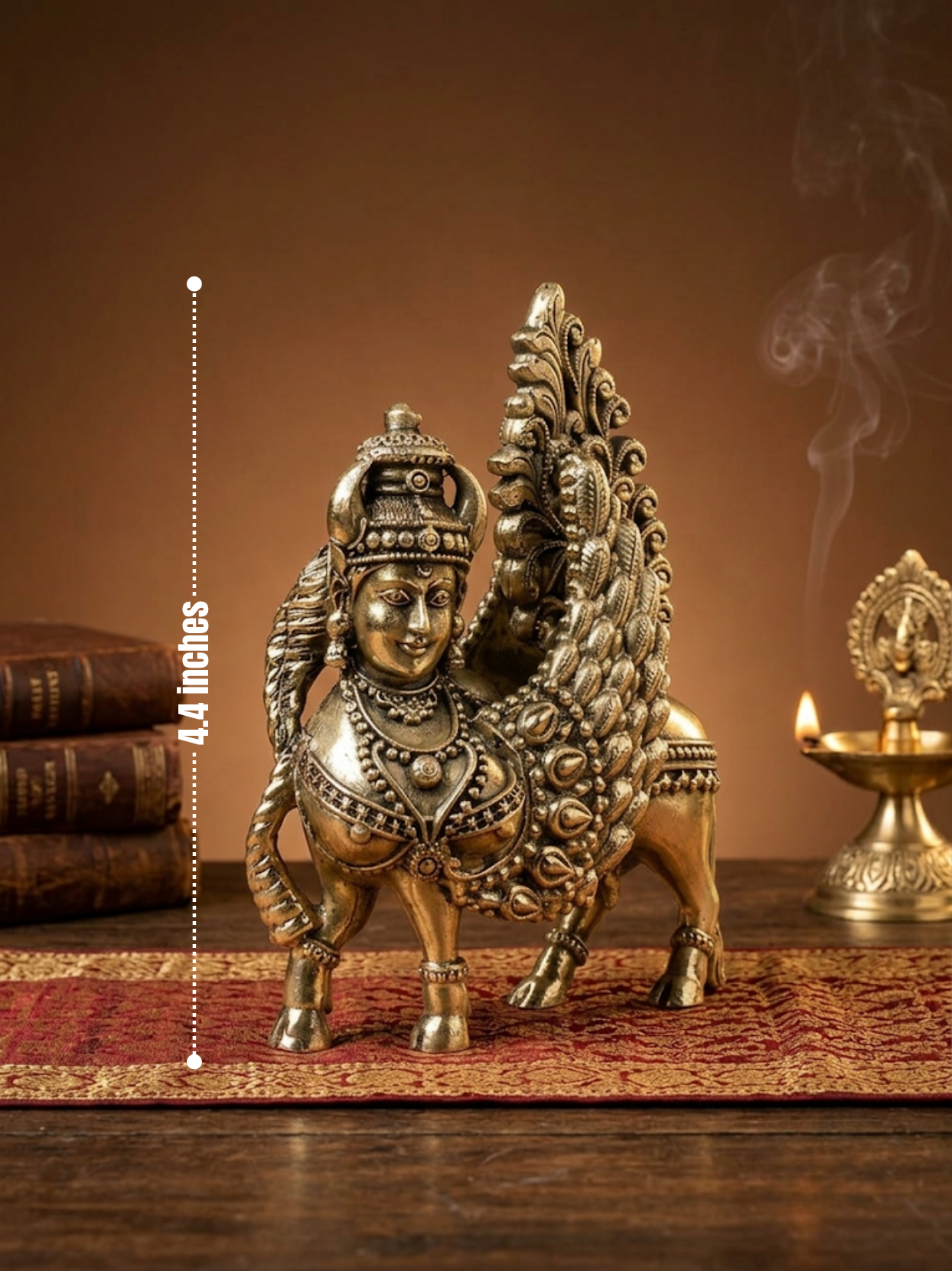 An ornate brass-colored winged horse statue with a human head stands on a patterned rug on a wooden surface, with stacked books and a lit oil lamp in the background. A vertical dotted measurement marker reads 4.