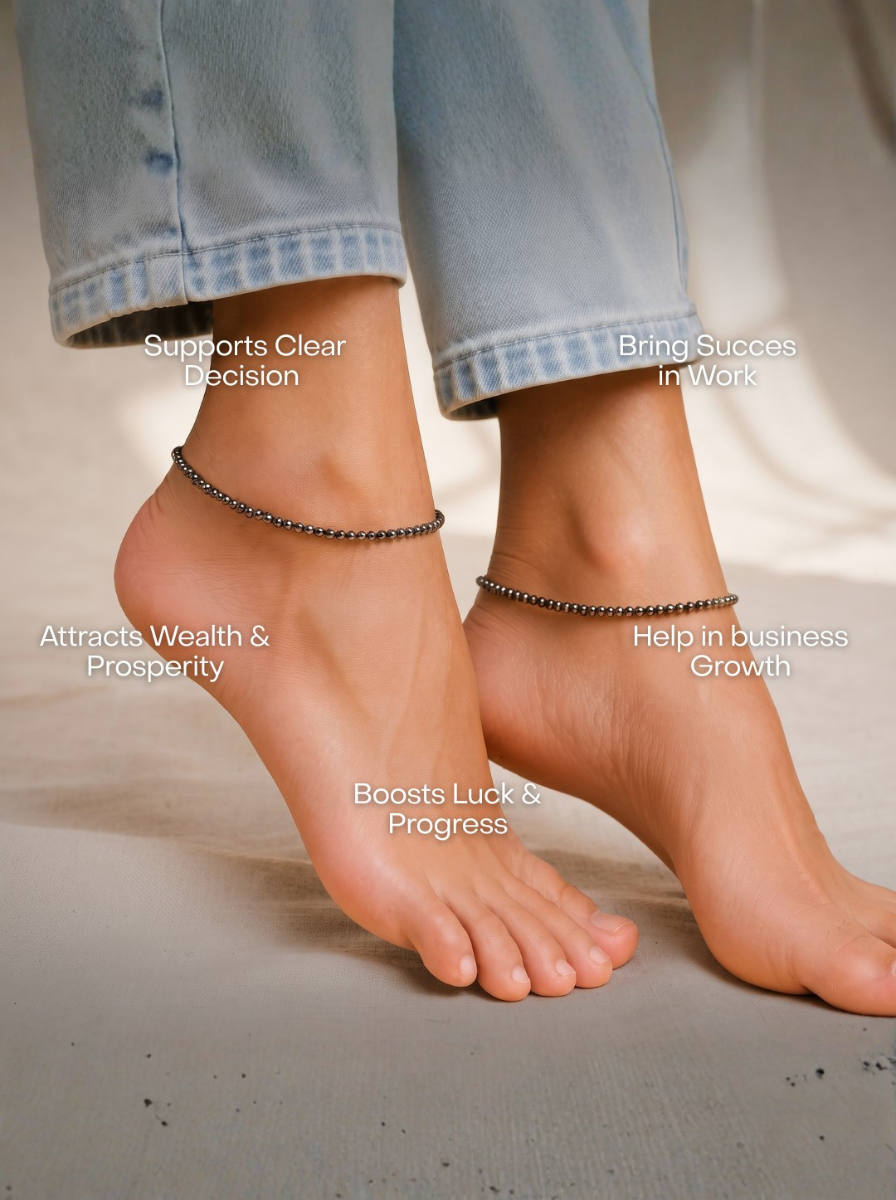 Natural Pyrite Diamond Cut Anklet for Wealth, Success & Protection, A close-up of a person's feet wearing two delicate metallic ankle bracelets, with light blue jeans rolled up. White text overlays claim benefits such as 'Supports Clear Decision', 'Bring Success in Work', 'Attracts Wealth & Prosperity', 'Help in business Growth', and 'Boosts Luck & Progress'.