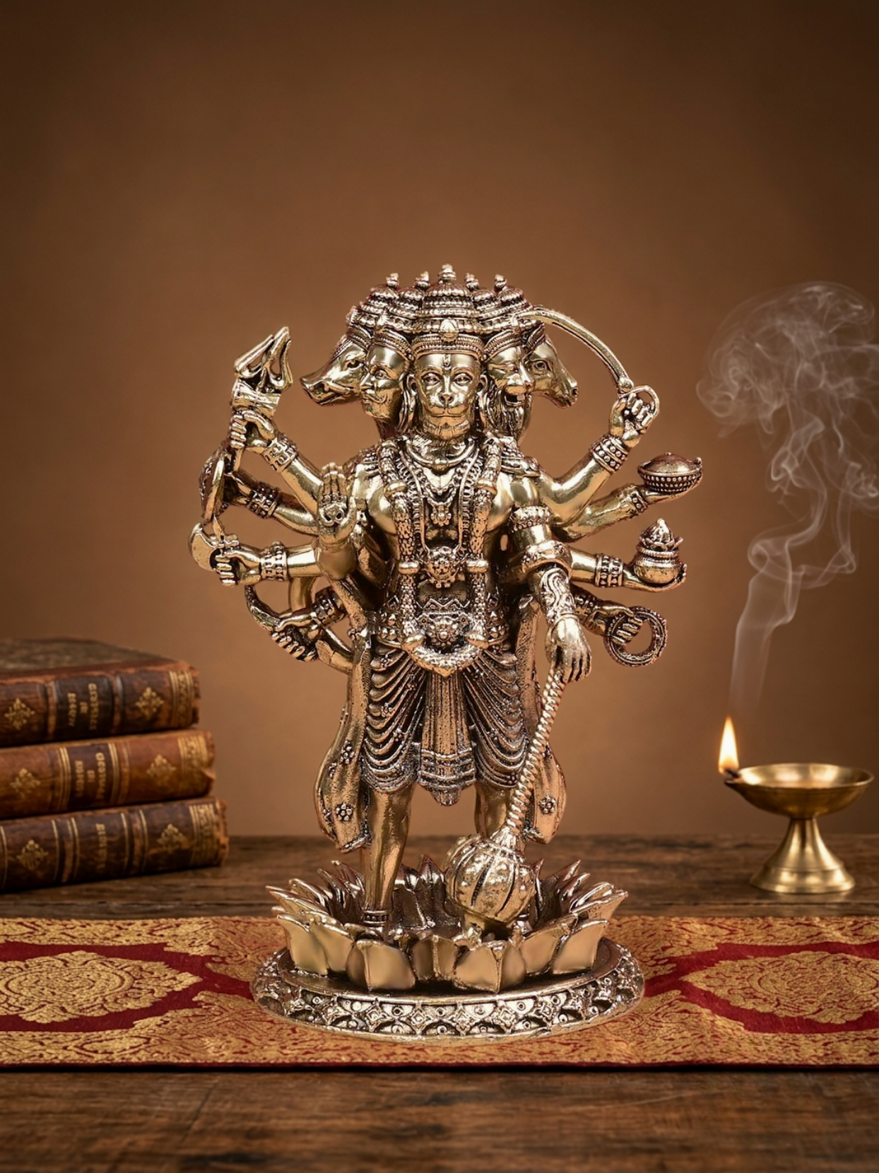 Front view of the Mani Monk Ashtadhatu Standing Panchmukhi Hanuman idol, styled on a traditional pooja altar with incense and a lit diya