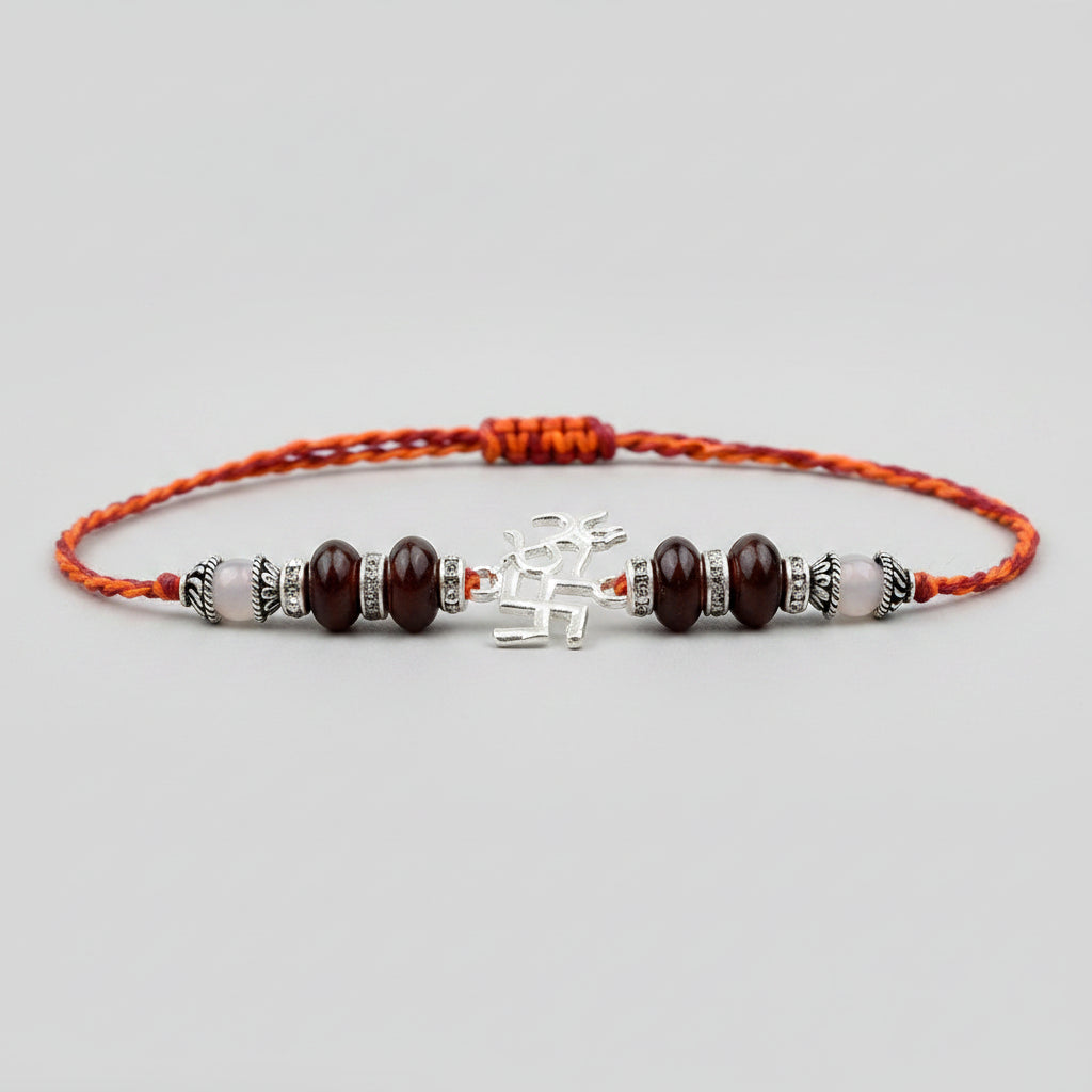 OM Design Rakhi in Pure Silver with Red Sandalwood Bead in thread