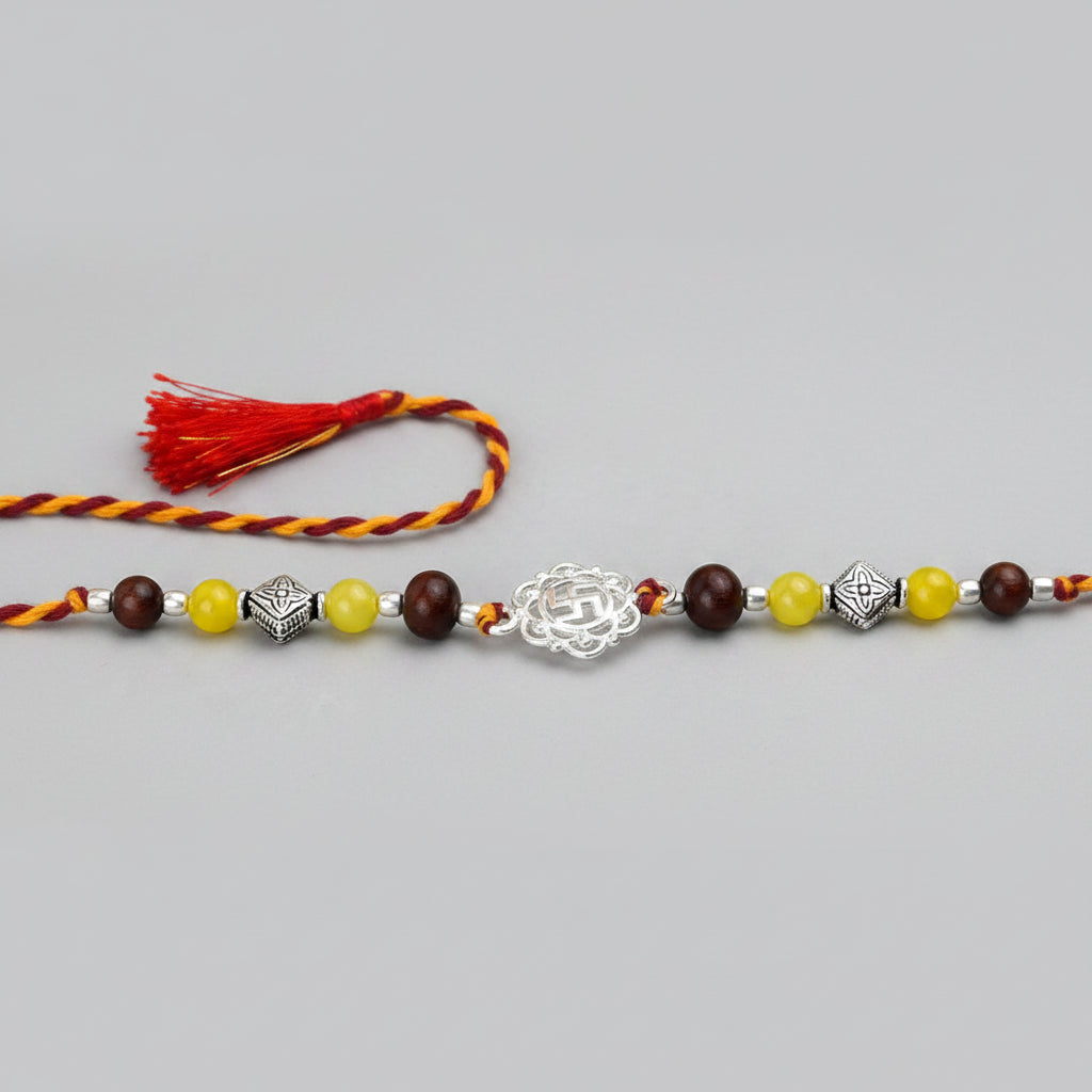 Swastik Design Rakhi in Pure Silver with Red Sandalwood Bead in thread