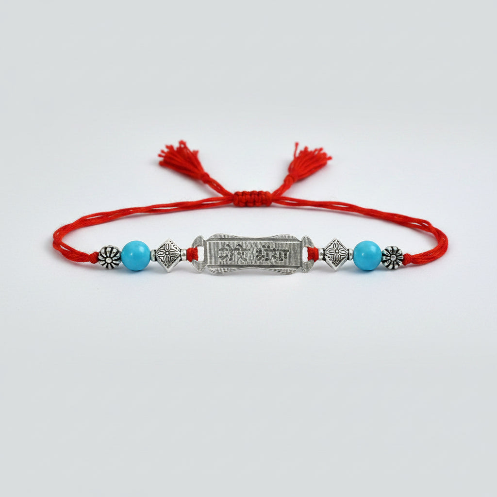 Turquoise beads Rakhi with pure silver accessories in thread