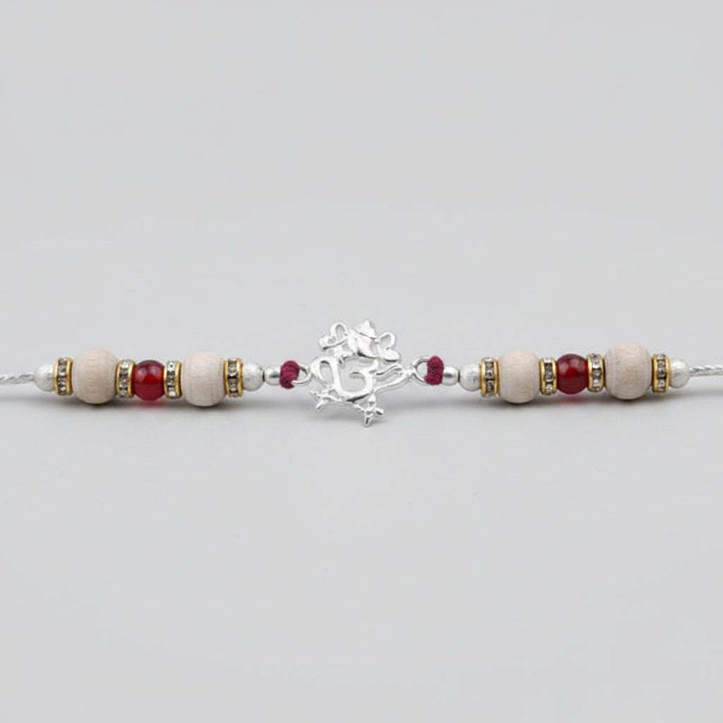 OM Design Rakhi in Pure Silver with Sandalwood Bead in thread